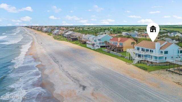 bird's eye view featuring a residential view, a beach view, and a water view