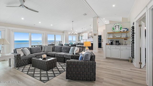 living room with visible vents, a water view, ceiling fan with notable chandelier, recessed lighting, and light wood-style floors