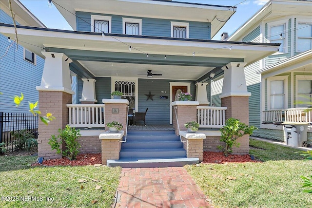 view of exterior entry with a porch and brick siding