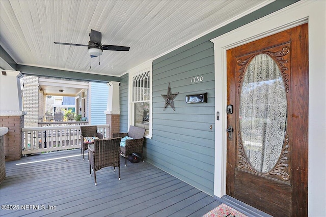 deck featuring a porch and ceiling fan