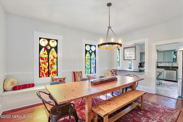 dining area with an inviting chandelier and hardwood / wood-style floors