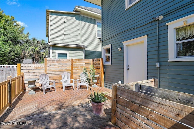 wooden terrace featuring fence