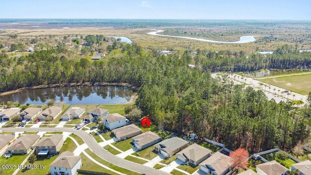 aerial view with a residential view, a forest view, and a water view