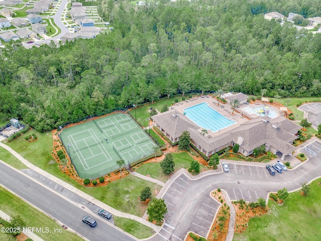 birds eye view of property with a view of trees