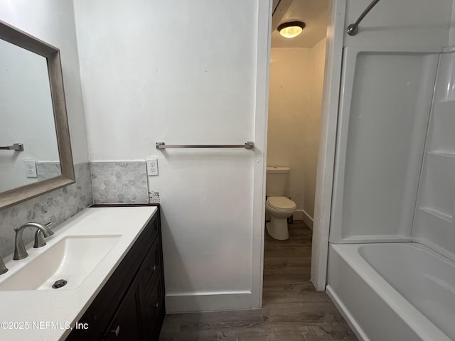 bathroom featuring vanity, toilet, and wood finished floors