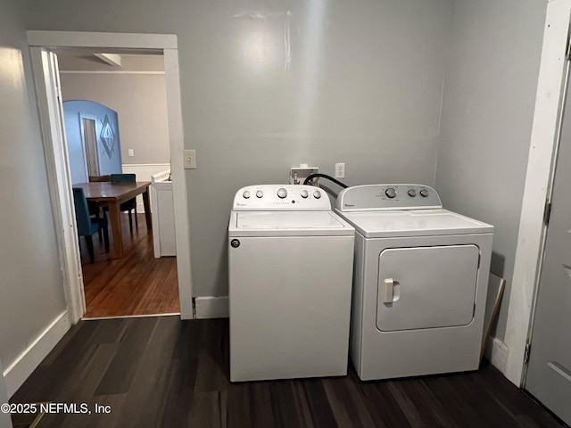 laundry room with dark wood-type flooring, separate washer and dryer, and laundry area