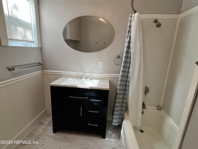 bathroom featuring wainscoting, marble finish floor, vanity, and shower / bathtub combination with curtain