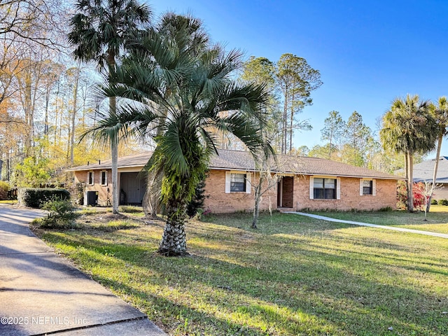 ranch-style house featuring a front yard, central air condition unit, and brick siding