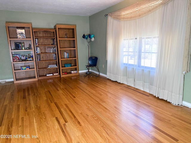 interior space featuring wood finished floors and baseboards