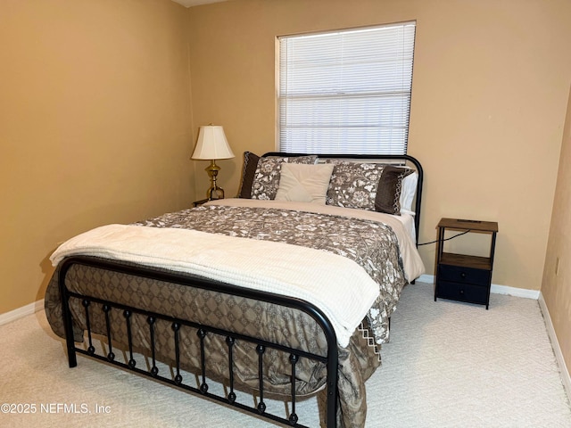 carpeted bedroom featuring baseboards