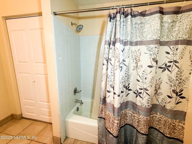 full bath featuring tile patterned floors, shower / bath combination with curtain, and baseboards