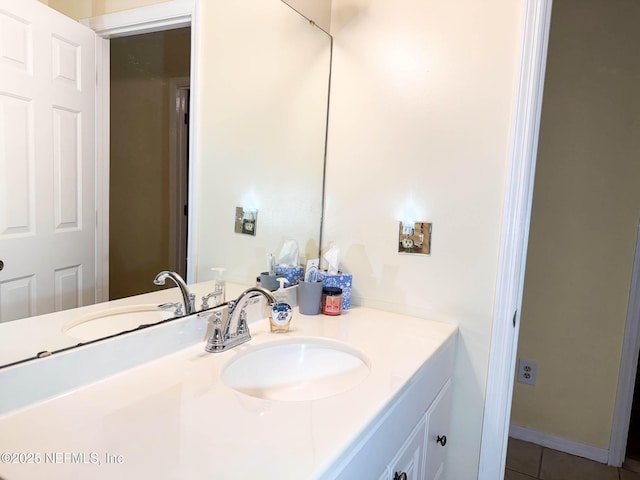 bathroom featuring baseboards, vanity, and tile patterned flooring