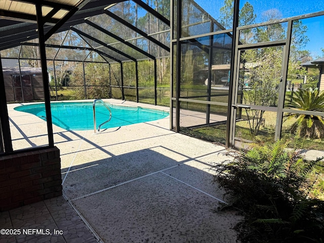 outdoor pool featuring an outbuilding, a lanai, and a patio area