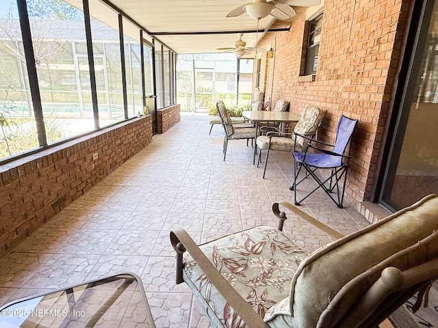 sunroom with a ceiling fan