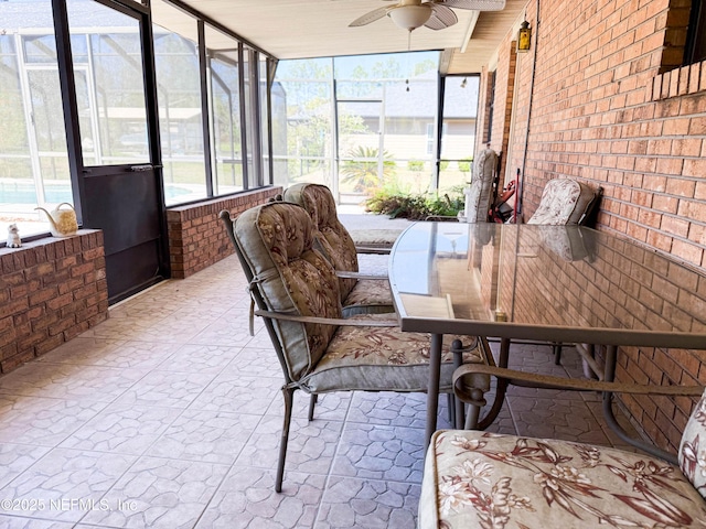 sunroom / solarium with a wealth of natural light and a ceiling fan