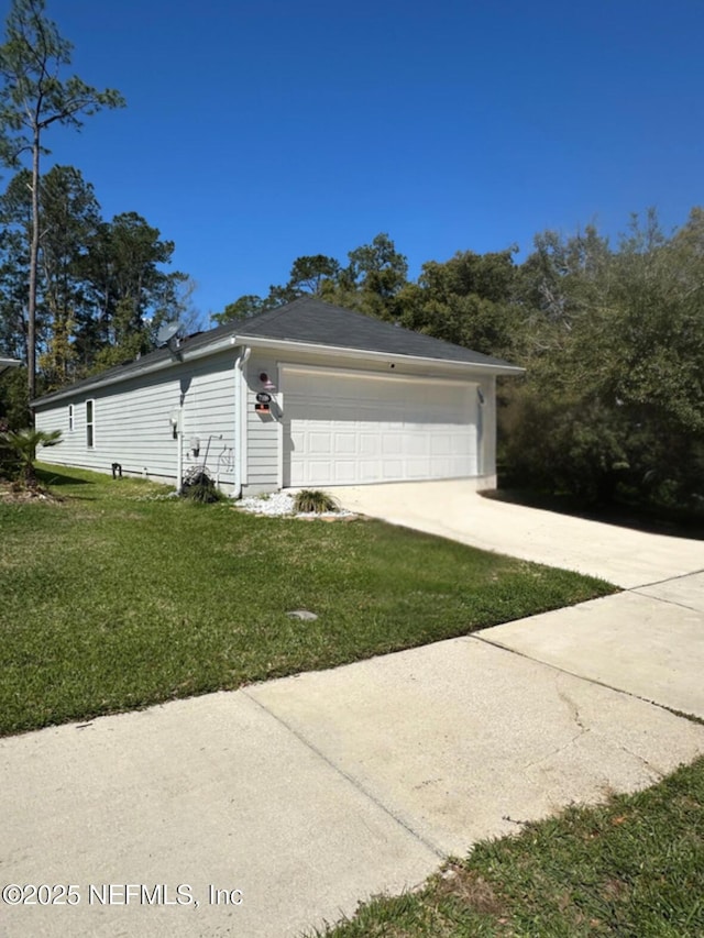 exterior space featuring a lawn and driveway