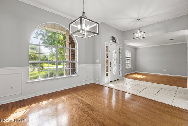 109 N Lake Cunningham Ave, Saint Johns, FL 32259 - entryway with wood finished floors, a notable chandelier, and wainscoting