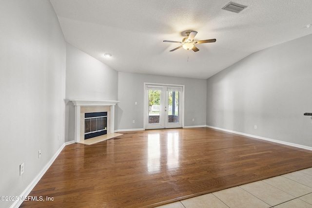 109 N Lake Cunningham Ave, Saint Johns, FL 32259 - unfurnished living room featuring a fireplace, wood finished floors, ceiling fan, and visible vents