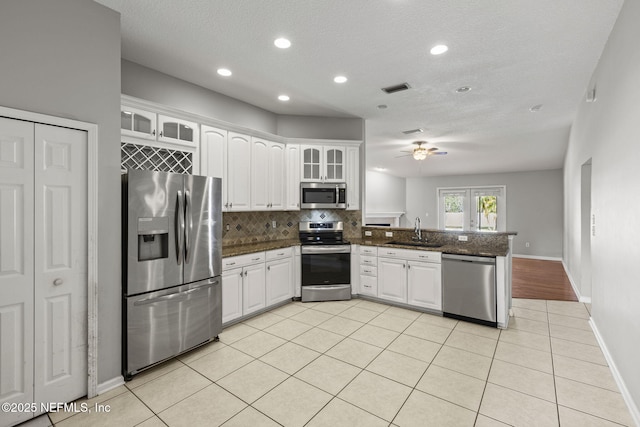 109 N Lake Cunningham Ave, Saint Johns, FL 32259 - kitchen with decorative backsplash, visible vents, a peninsula, stainless steel appliances, and a sink