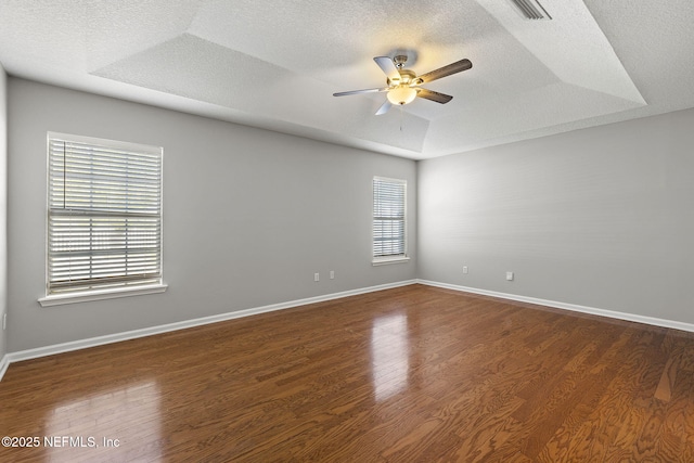 109 N Lake Cunningham Ave, Saint Johns, FL 32259 - unfurnished room with visible vents, baseboards, ceiling fan, dark wood finished floors, and a raised ceiling