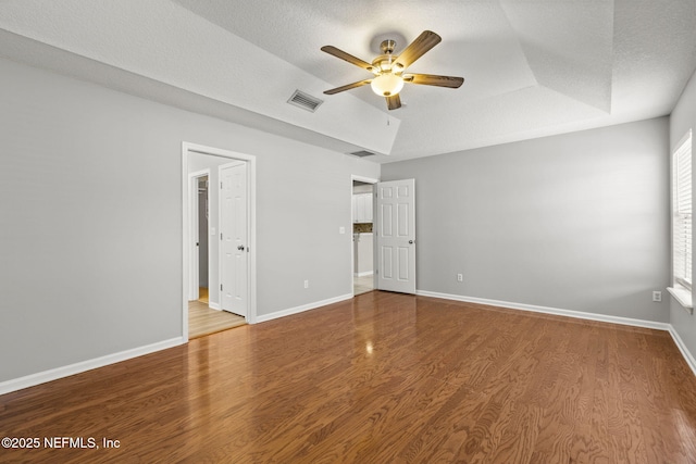 109 N Lake Cunningham Ave, Saint Johns, FL 32259 - interior space with a textured ceiling, visible vents, baseboards, wood finished floors, and a tray ceiling