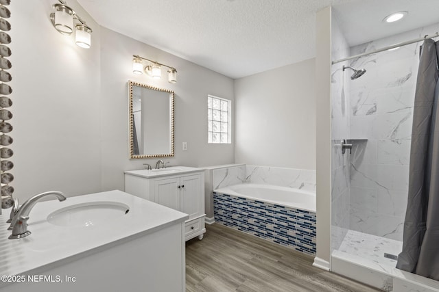 109 N Lake Cunningham Ave, Saint Johns, FL 32259 - full bathroom featuring a textured ceiling, tiled shower, a sink, and a garden tub