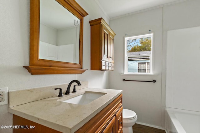 full bathroom featuring crown molding, toilet, vanity, and a tub to relax in