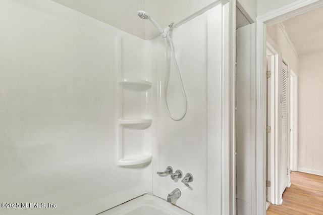 full bathroom with wood finished floors and shower / bathtub combination