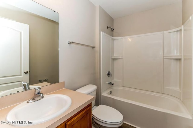 full bath featuring toilet, vanity, and bathing tub / shower combination