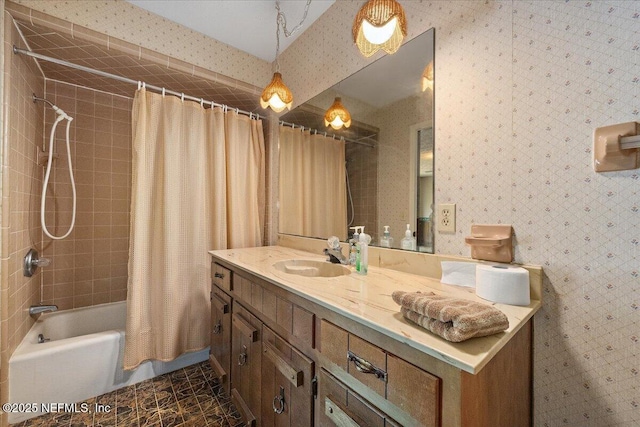 bathroom with shower / tub combo with curtain, vanity, and wallpapered walls