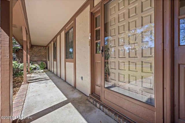 doorway to property featuring stucco siding