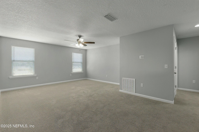 spare room with visible vents, baseboards, a ceiling fan, and carpet floors