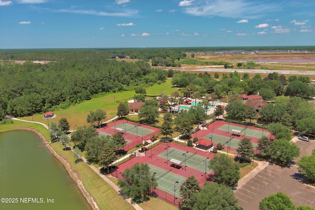 birds eye view of property featuring a water view and a view of trees