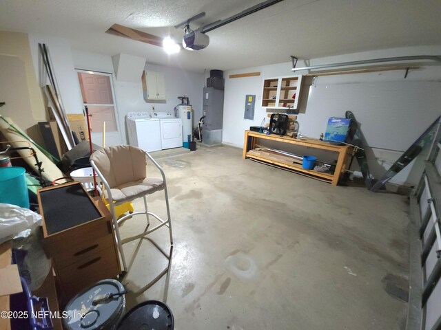 garage featuring heating unit, electric panel, a garage door opener, and washing machine and clothes dryer