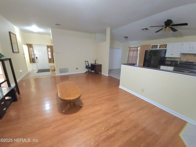 unfurnished living room with light wood-style flooring, a ceiling fan, visible vents, and baseboards