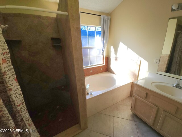 full bathroom featuring tile patterned floors, a shower stall, vanity, and a garden tub