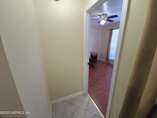 hall with tile patterned floors and baseboards