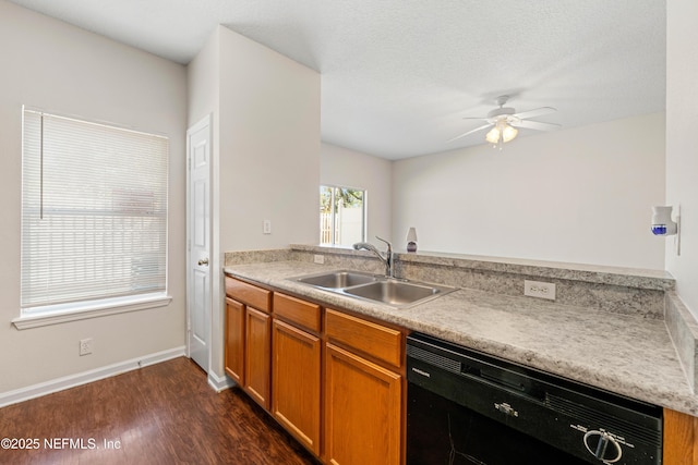 kitchen featuring a ceiling fan, a sink, dark wood-style floors, light countertops, and dishwasher