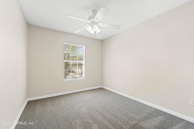 spare room featuring a textured ceiling, carpet flooring, baseboards, and ceiling fan