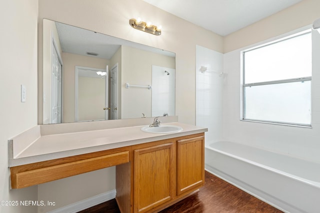 bathroom with vanity, wood finished floors, visible vents, and shower / bathtub combination