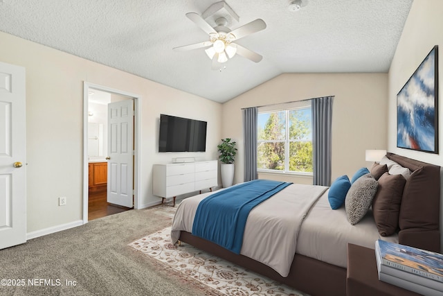 carpeted bedroom featuring a ceiling fan, baseboards, vaulted ceiling, ensuite bathroom, and a textured ceiling