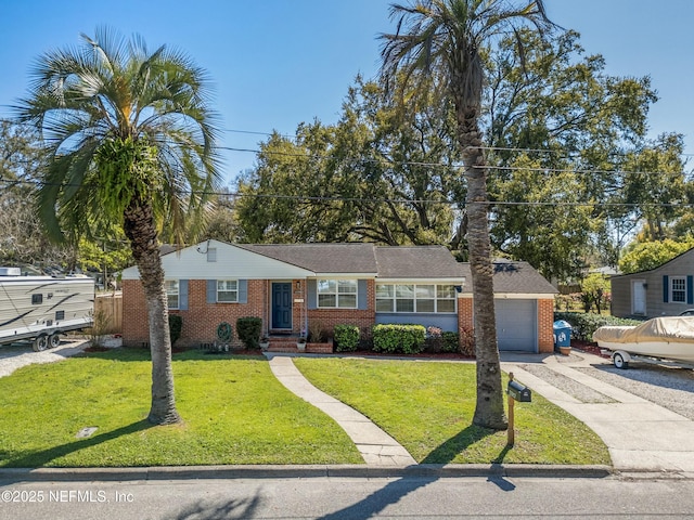 ranch-style home with a front yard, brick siding, and a garage