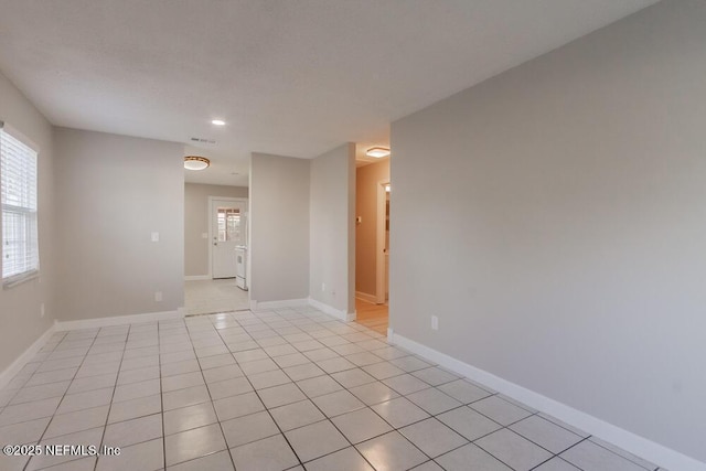 unfurnished room featuring visible vents, baseboards, and light tile patterned flooring