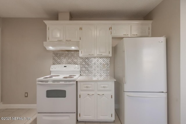 kitchen featuring under cabinet range hood, white appliances, white cabinets, light countertops, and decorative backsplash