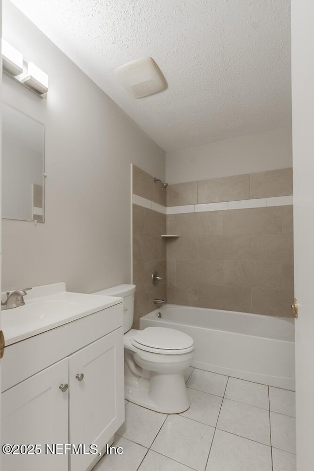 bathroom featuring shower / washtub combination, toilet, vanity, tile patterned floors, and a textured ceiling