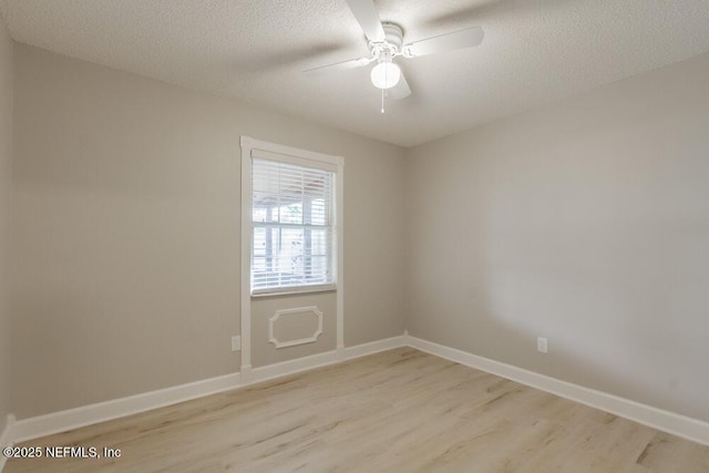 empty room with light wood-style flooring, a textured ceiling, baseboards, and a ceiling fan