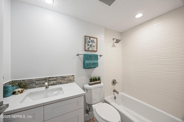 full bath featuring vanity, visible vents, a textured ceiling, bathing tub / shower combination, and toilet