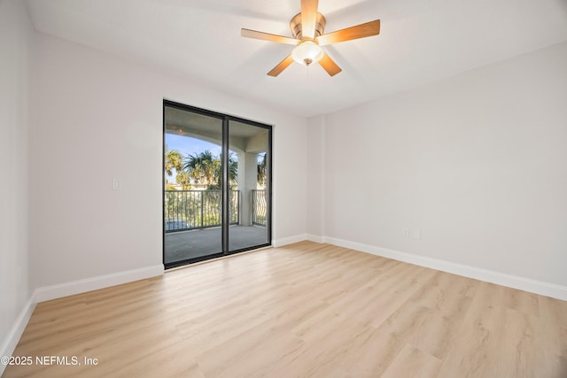 spare room featuring a ceiling fan, wood finished floors, and baseboards