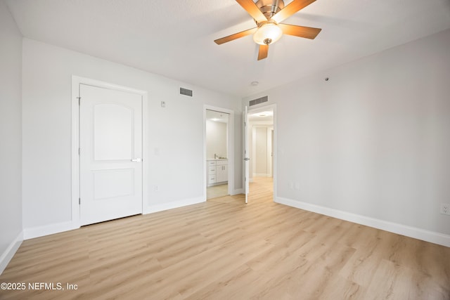 unfurnished bedroom with visible vents, baseboards, and light wood-style floors