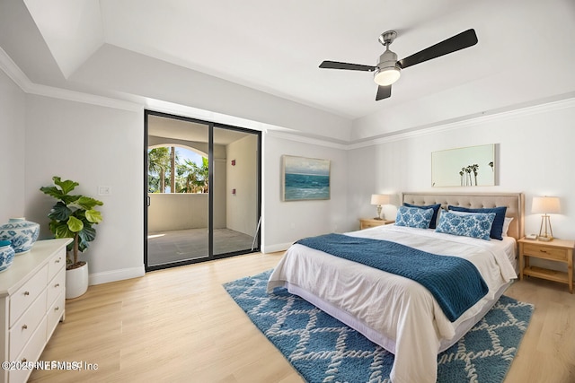 bedroom with light wood-style flooring, ornamental molding, access to outside, a raised ceiling, and ceiling fan